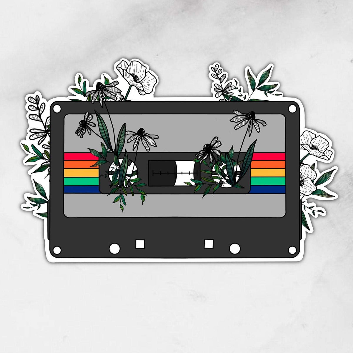 cassette sticker with florals and a rainbow across the front 
